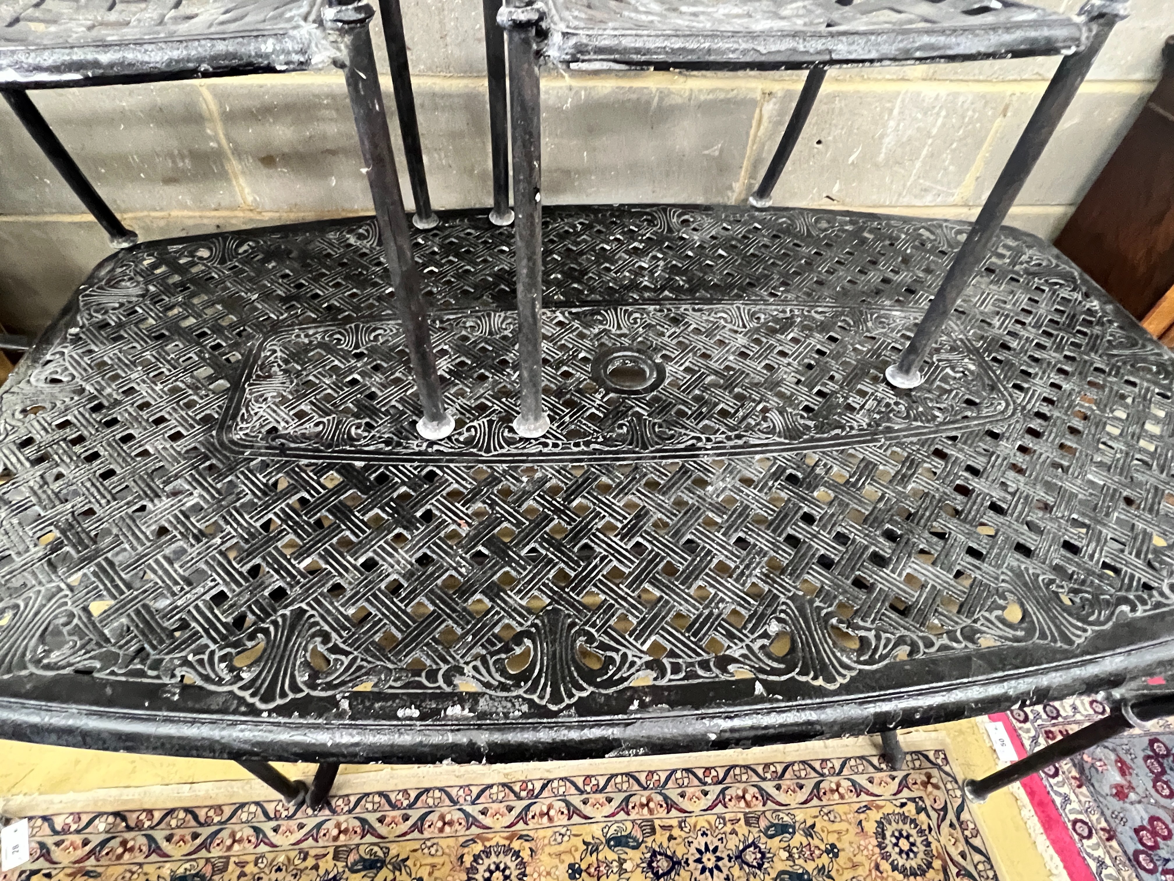 A rectangular painted aluminium garden table, length 164cm, depth 96cm, height 71cm and four similar elbow chairs